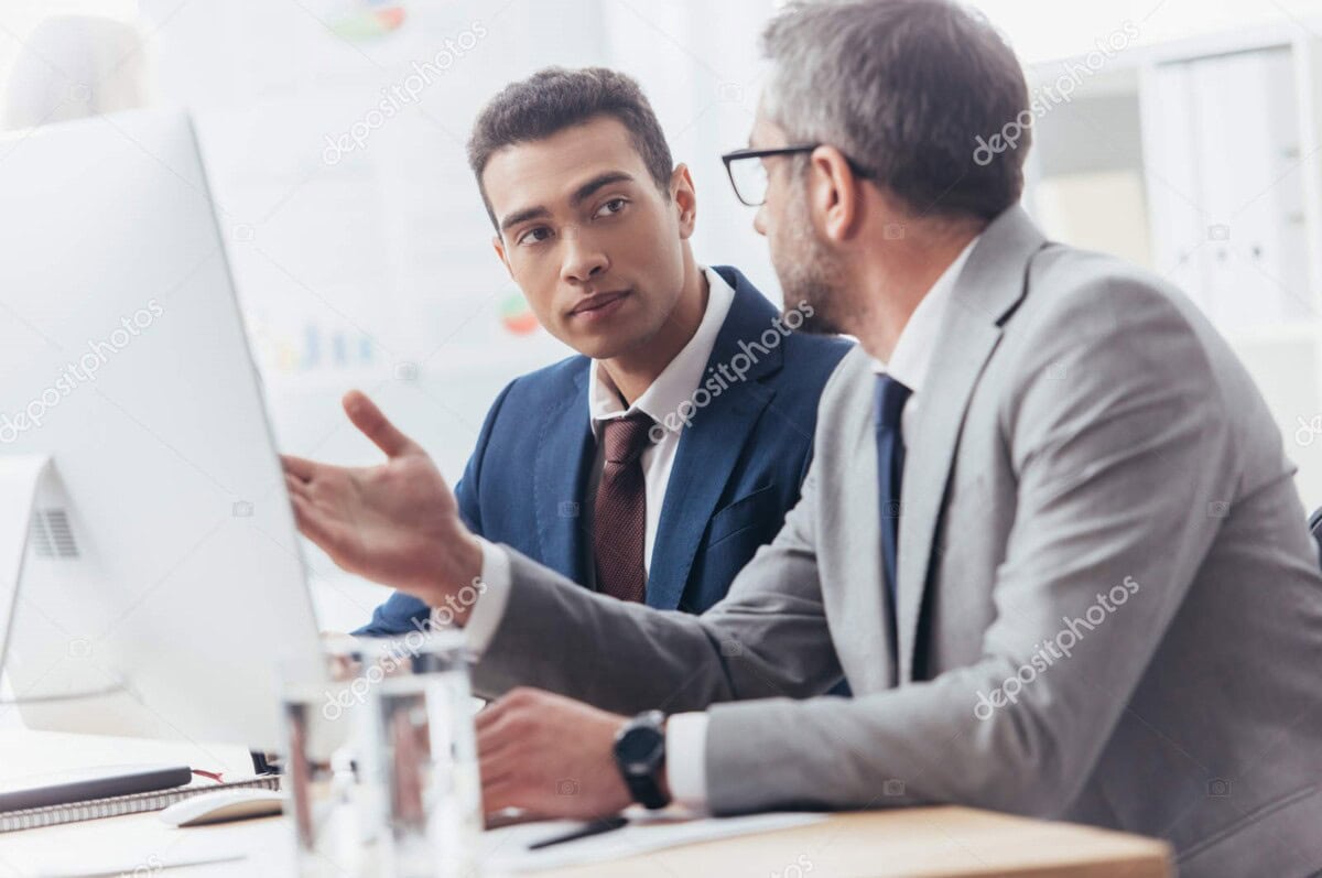 depositphotos 233887396 stock photo two professional businessmen using desktop