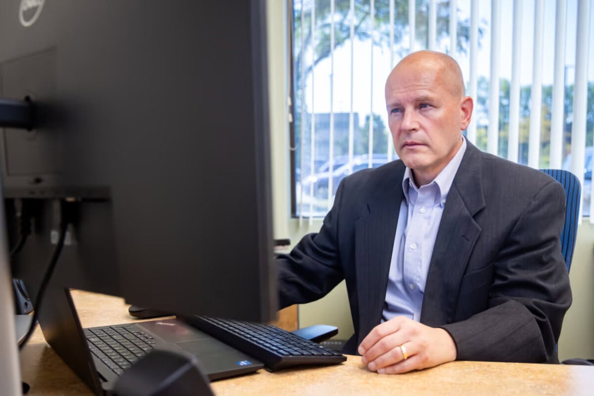 a professional working on a laptop in an office.